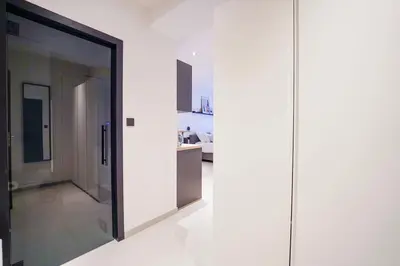 a room with a large glass door and a kitchen at Charming studio in the heart of Liege - total comfort in Liège