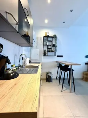 a kitchen with a sink and a wooden counter top at Charming studio in the heart of Liege - total comfort in Liège