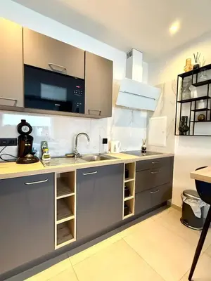 a kitchen with a sink and a microwave at Charming studio in the heart of Liege - total comfort in Liège