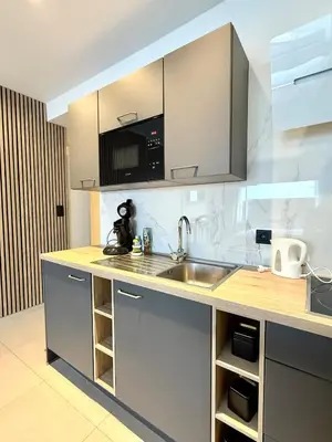 a kitchen with a sink and a counter top at Charming studio in the heart of Liege - total comfort in Liège