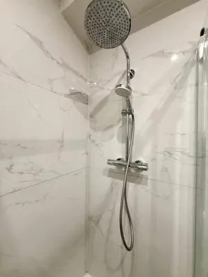 a shower with a shower head in a bathroom at Charming studio in the heart of Liege - total comfort in Liège