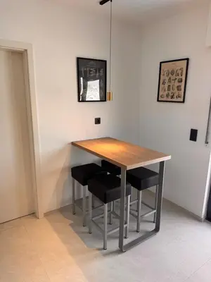 a dining room table with black chairs around it at Haus Orion in Eupen