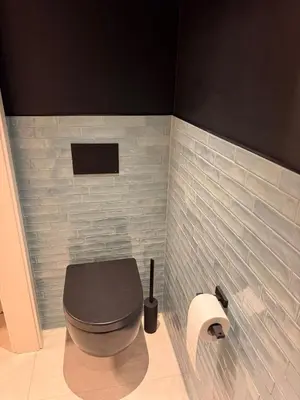 a bathroom with a toilet and a toilet paper roll at Haus Orion in Eupen