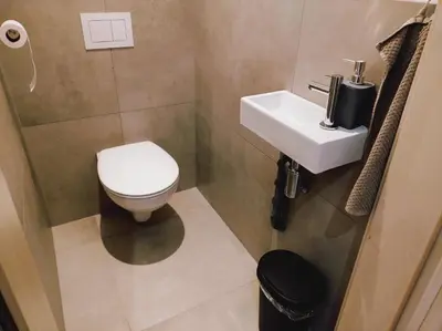 a small bathroom with a toilet and a sink at Riverside Holiday in Eupen