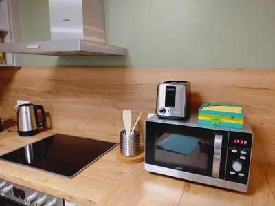 a microwave sitting on top of a kitchen counter at Riverside Holiday in Eupen
