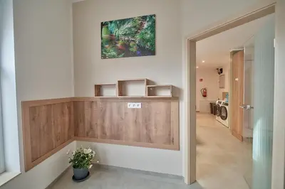 a hallway in a house with a painting on the wall at Riverside Holiday in Eupen