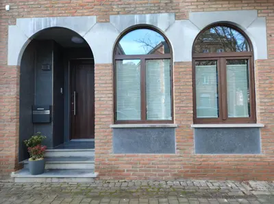 a brick building with two windows and a door at Riverside Holiday in Eupen