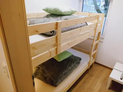 a wooden bunk bed with pillows on top at Riverside Holiday in Eupen
