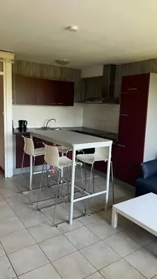 a kitchen with a white table and chairs at Serene Oasis - your Idyllic Escape in La Calamine