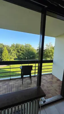 a piano on a patio with a view of a field at Serene Oasis - your Idyllic Escape in La Calamine