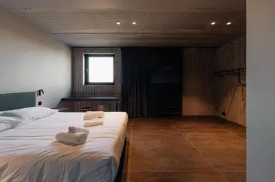 a bedroom with a bed with towels on it at Coliving - Bord de Meuse - L'échappée Mosane in Oupeye