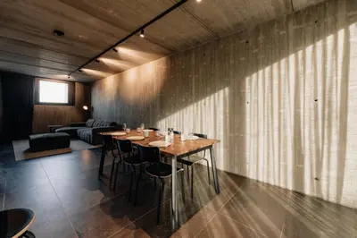 a dining room with a table and a couch at Coliving - Bord de Meuse - L'échappée Mosane in Oupeye
