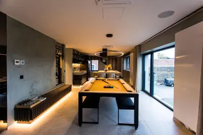 a large room with a ping pong table in it at Loft La Suite et sa Suite in Thimister
