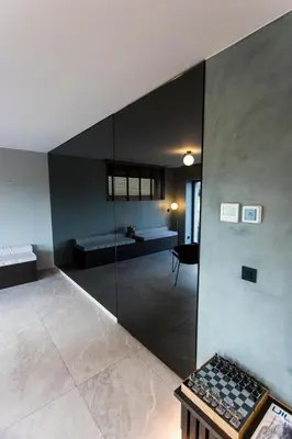 a room with a glass wall with a room with two beds at Loft La Suite et sa Suite in Thimister