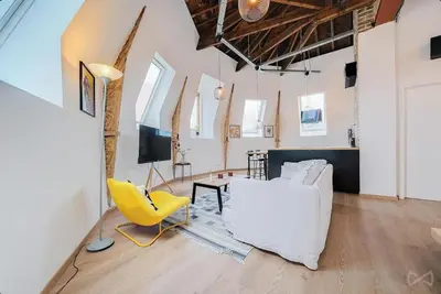 a living room with a white couch and a yellow chair at Logement temporaire haut de gamme Particuliers & entreprises in Liège