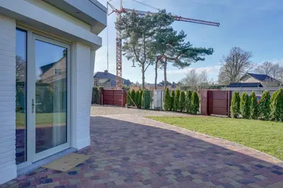 a house with a glass door on a brick driveway at 't Vennehuys in Genk