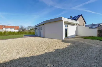 a white house with a gravel driveway at 't Vennehuys in Genk