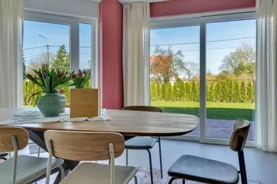 a dining room with a table and chairs and a window at 't Vennehuys in Genk
