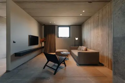 a living room with a couch and a chair at Coliving - Bord de Meuse - L'écrin Vert in Oupeye