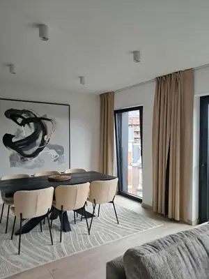 a dining room with a table and chairs at Chez Vincent, parking gratuit in Liège