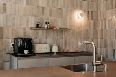 a kitchen with a sink and a counter top at Coliving - Bord de Meuse - L'atelier de la Meuse in Oupeye