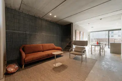 a living room with a couch and a table at Coliving - Bord de Meuse - L'atelier de la Meuse in Oupeye