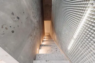 a staircase with a metal wall and a window at Coliving - Bord de Meuse - L'atelier de la Meuse in Oupeye