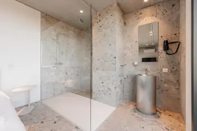 a shower with a glass door in a bathroom at Coliving - Bord de Meuse - L'atelier de la Meuse in Oupeye