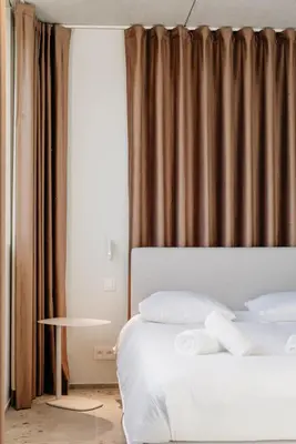a bedroom with a bed and a window with curtains at Coliving - Bord de Meuse - L'atelier de la Meuse in Oupeye