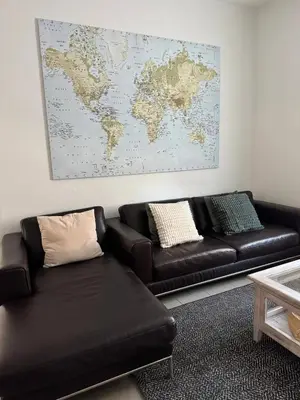 a living room with a couch and a map on the wall at Charming Apartment in Lontzen on 72 m² in Lontzen