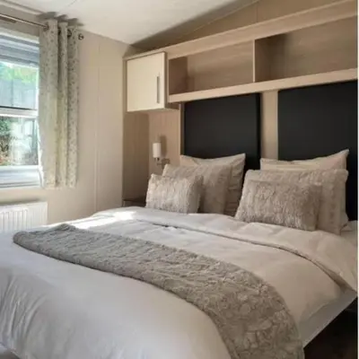 a large white bed in a bedroom with a window at Casa Nymphaea in Kinrooi