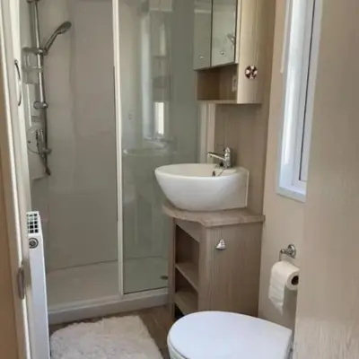 a bathroom with a sink and a shower and a toilet at Casa Nymphaea in Kinrooi