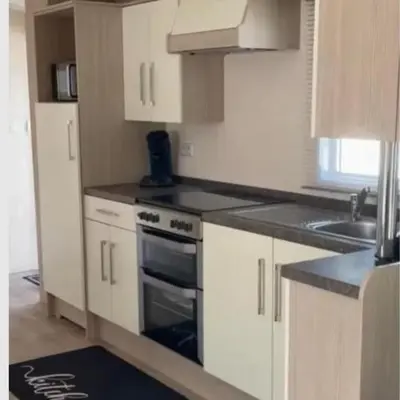 a kitchen with white cabinets and a stove top oven at Casa Nymphaea in Kinrooi