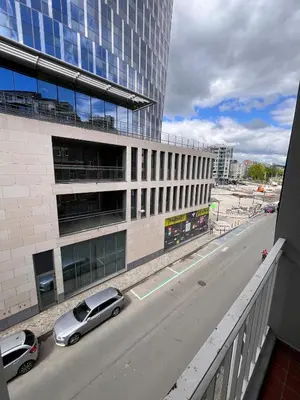 a car is parked in front of a building at Studio moderne et confort - Guillemins in Liège