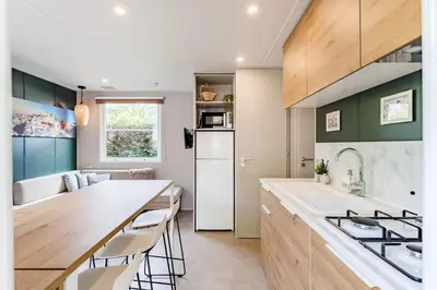 a kitchen with a white refrigerator and a counter at Camping Papillon Kinrooi - Vakantiehuis Familie 6P in Kinrooi
