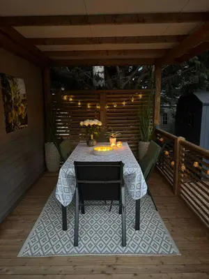 a patio with a table and chairs on a deck at Camping Papillon Kinrooi - Vakantiehuis Familie 6P in Kinrooi