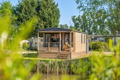 a tiny house in the middle of a field at Camping Papillon Kinrooi - Vakantiehuis Premium 4P in Kinrooi