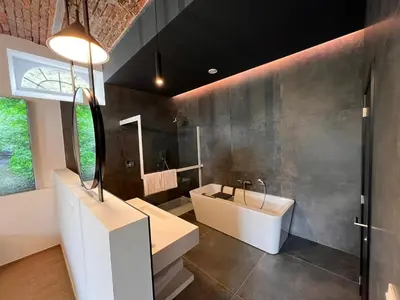 a bathroom with a sink and a bath tub at L'Orée des Thermes in Chaudfontaine