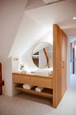 a bathroom with a sink and a mirror at Héritage Collection - Suites in Verviers
