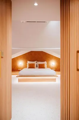 a bedroom with a bed with two pillows on it at Héritage Collection - Suites in Verviers