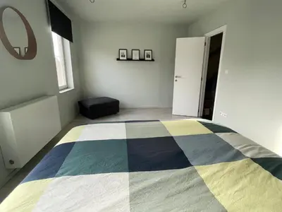 a bedroom with a bed with a colorful blanket on it at JoHa Haus in Hasselt