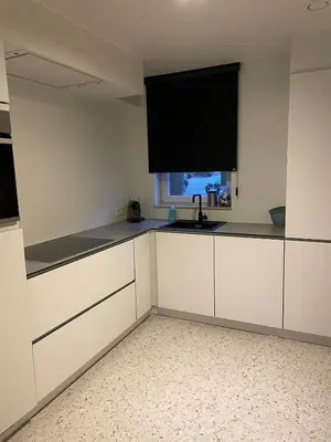 a kitchen with white cabinets and a sink and a window at JoHa Haus in Hasselt