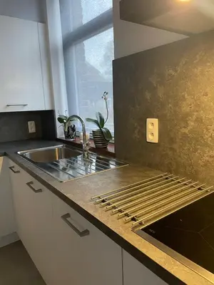 a kitchen with a sink and a counter top at Le Havre de paix in Oupeye