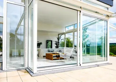 a living room with sliding glass doors at Villa Bianca in Dalhem