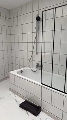 a bathroom with a bath tub with a shower at Studio Cosy rénové au Centre de Liège in Liège