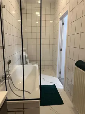 a bathroom with a shower and a bath tub at 1 Chambre et Sofa Bed en plein cœur de Liege in Liège