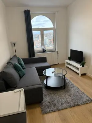 a living room with a couch and a coffee table at Appartement fraîchement rénové de 1 chambre et Sofa Bed en plein Cœur de Liege in Liège