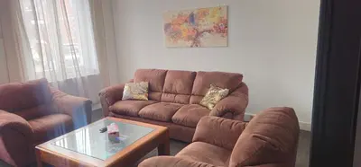 a living room with two couches and a coffee table at Appartement 2 chambre Liege in Liège