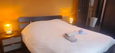 a bedroom with a white bed with towels on it at Appartement 2 chambre Liege in Liège