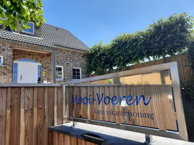 a wooden fence with a sign that reads mood women live watching at Holiday Home Mooi - Voeren in Voeren